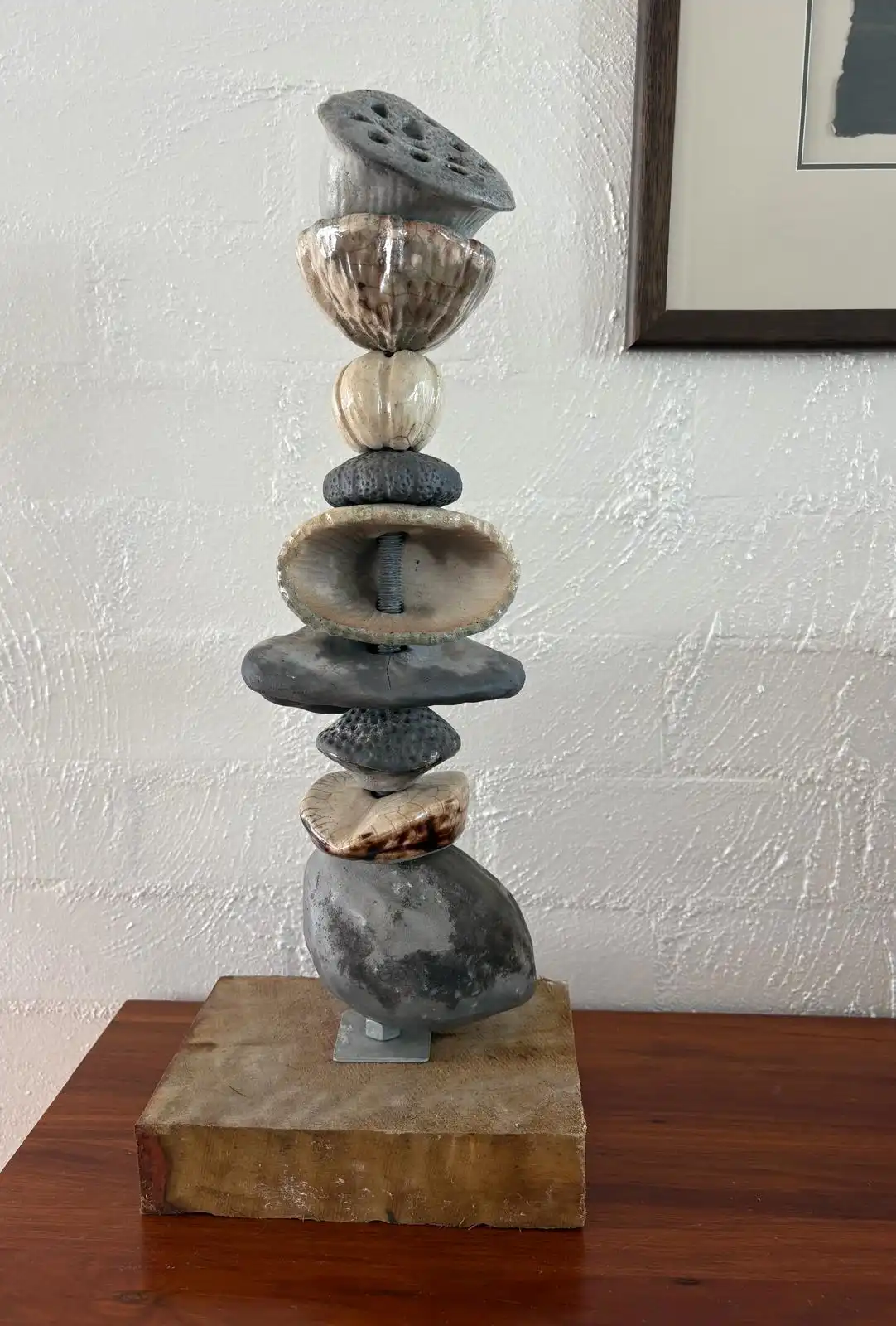 Stacked ceramic totem on a timber base