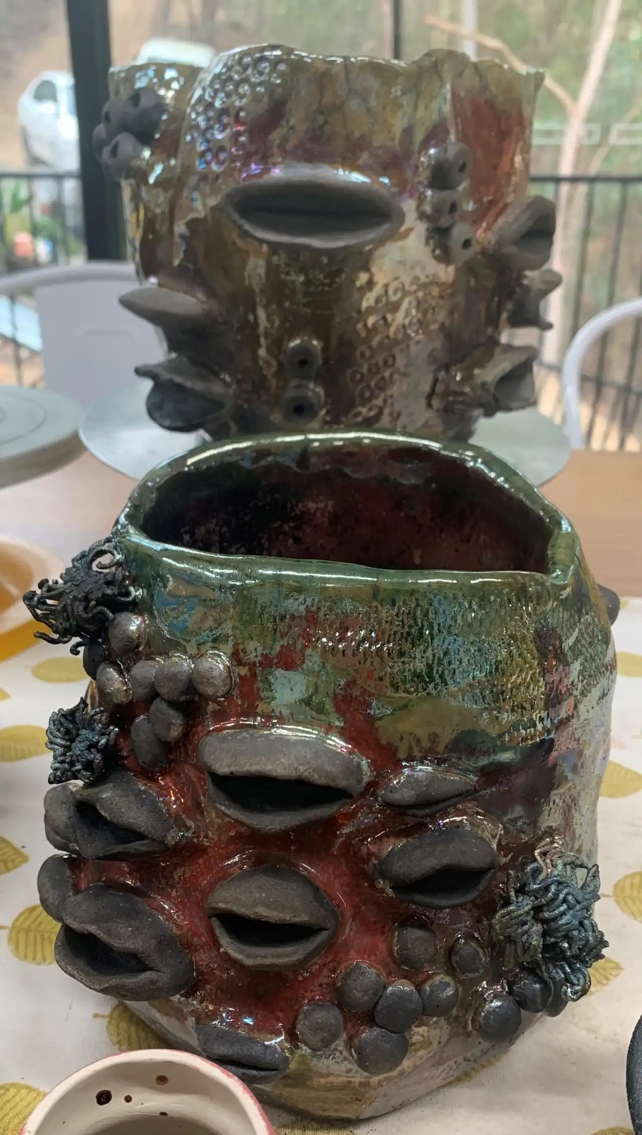Raku-fired vase covered in sculpted banksia seed pods